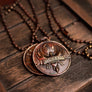Love Everybody pendant displayed on a wooden trunk