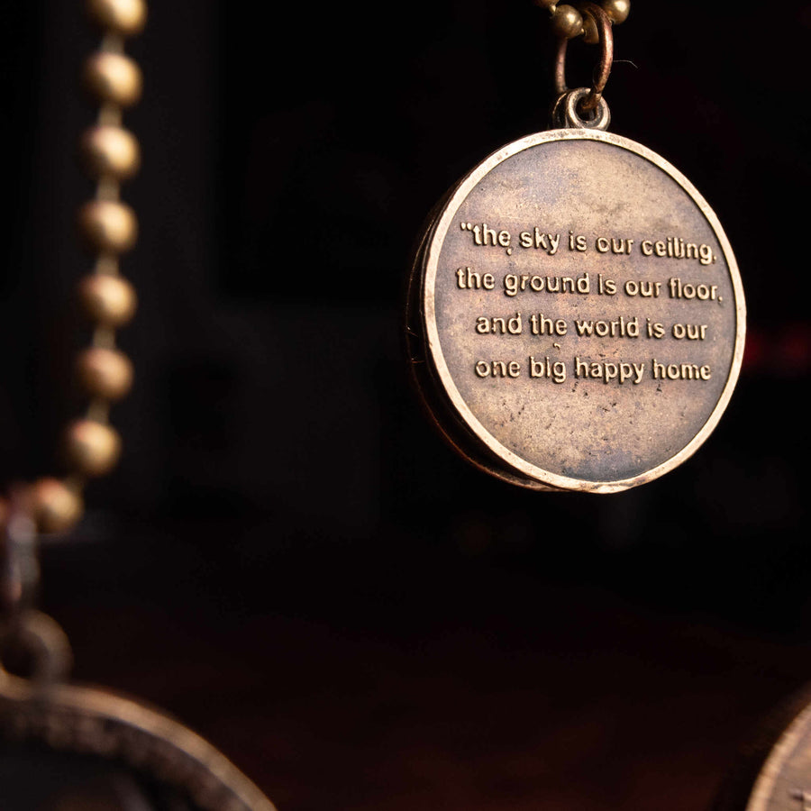Closeup of medallion inscribed with inspirational phrase, side A