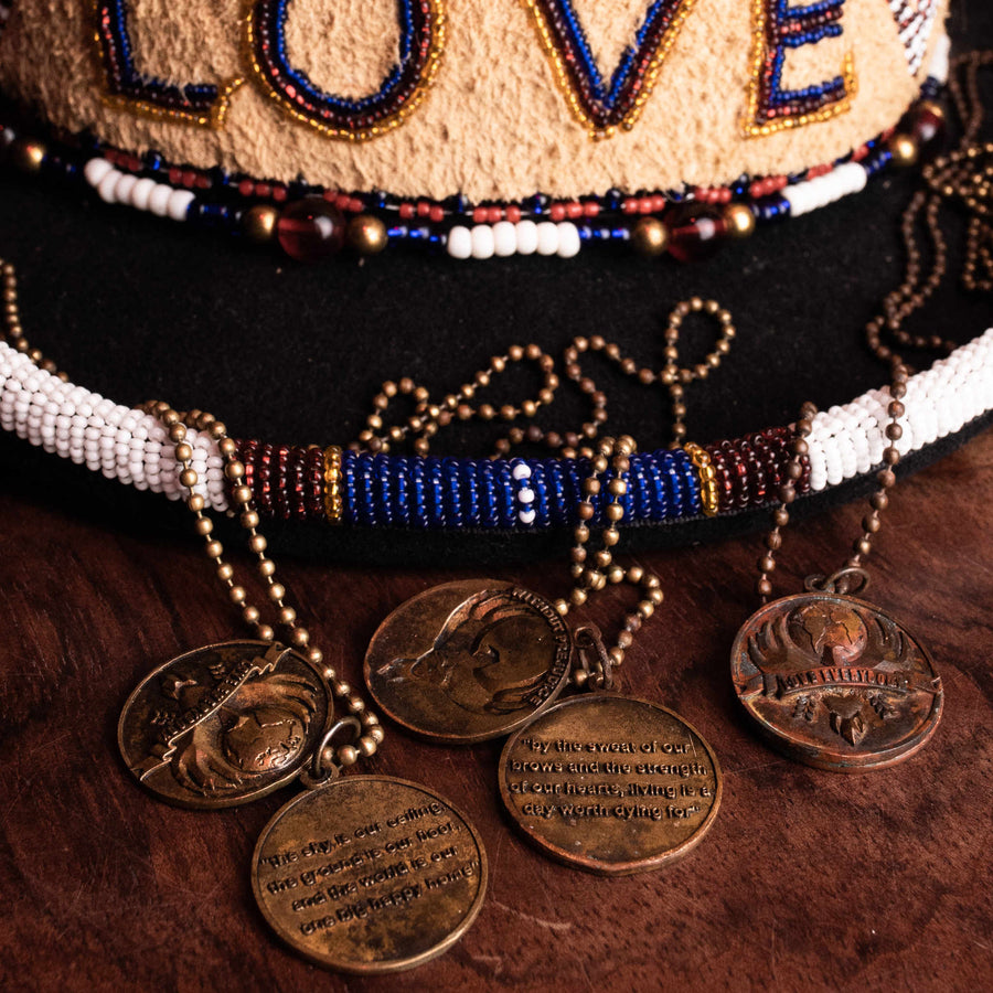 Necklaces draped across the brim of Big Kenny's Love top hat